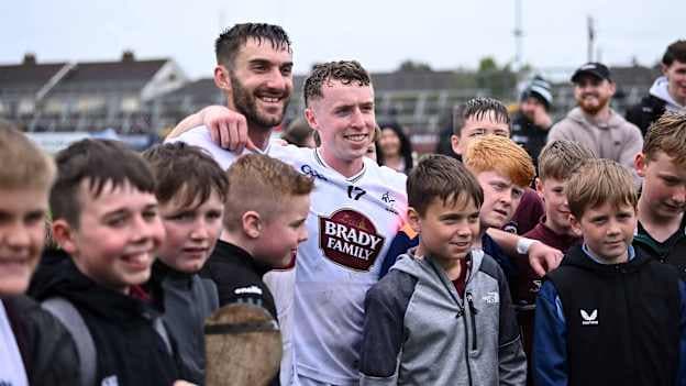 Kildare players, Darragh Melville and Jack Travers, celebrate with supporters at Cedral St Conleth's Park. Photo by Piaras Ó Mídheach/Sportsfile